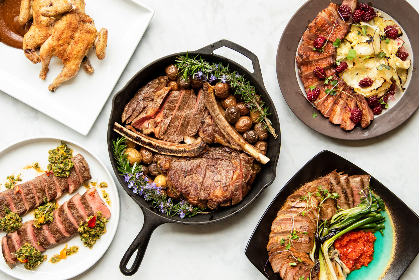 An array of 5 cooked and plated meats